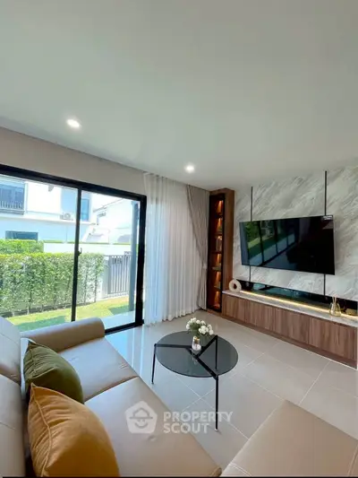 Modern living room with sleek design, large windows, and stylish furniture.