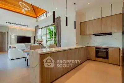 Luxurious open-layout kitchen and living room with modern design and elegant finishes.