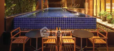 Luxurious rooftop pool with elegant seating area and ambient lighting