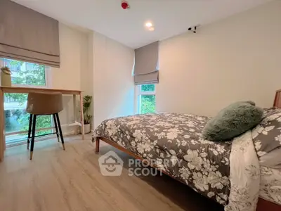 Cozy bedroom with modern decor and large window view