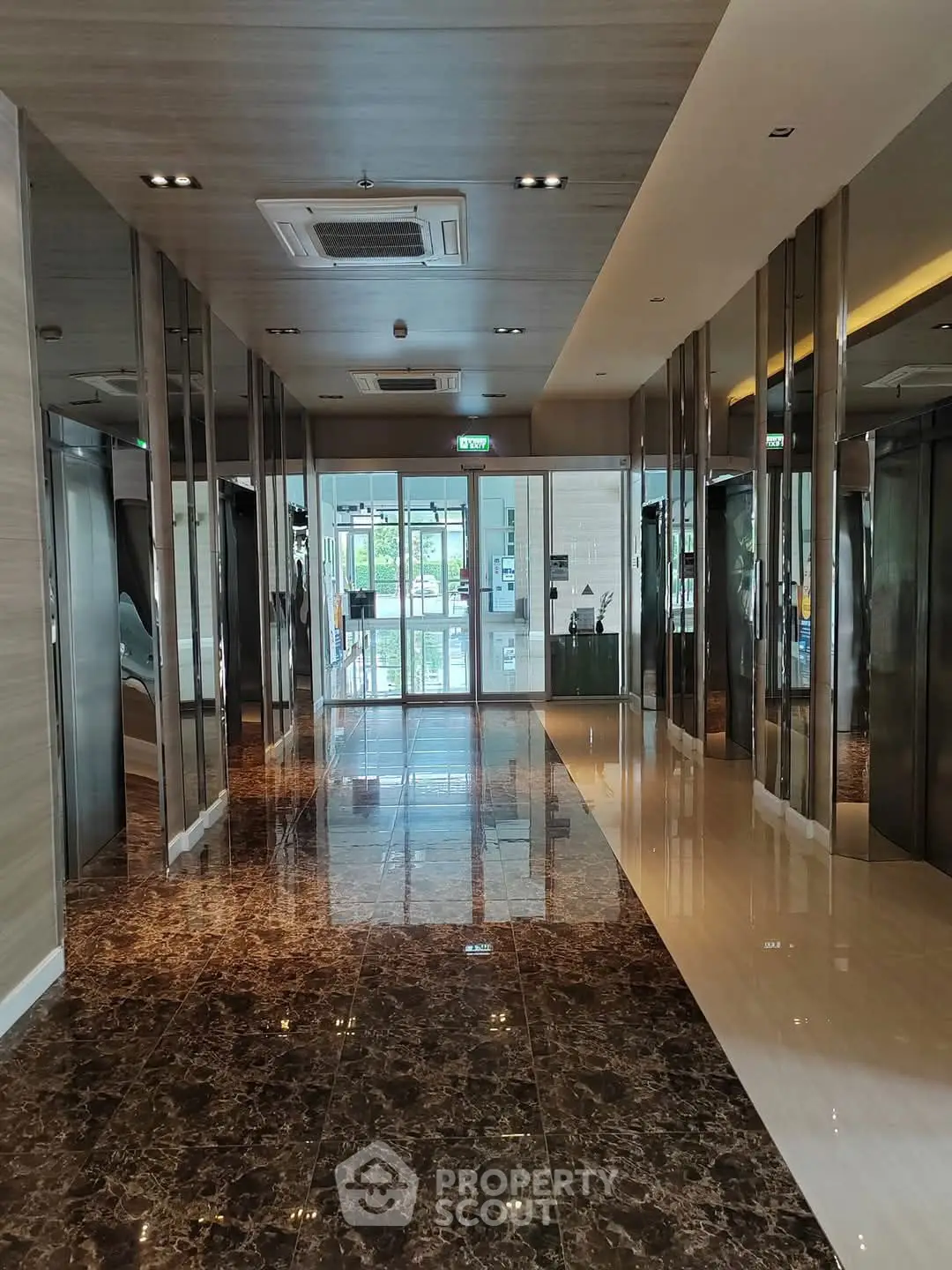 Luxurious modern elevator lobby with marble flooring and sleek design.