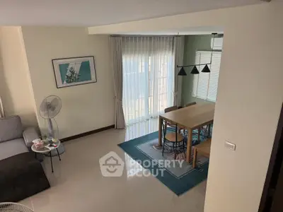 Spacious living and dining area with modern decor and natural light