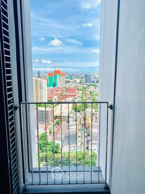 Stunning cityscape view from a high-rise balcony with vibrant skyline.