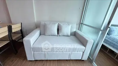 Modern living room with cozy sofa and dining area in a stylish apartment.