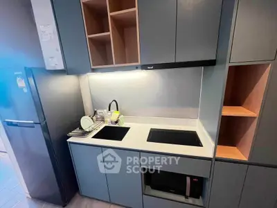 Modern kitchen with sleek cabinetry and built-in appliances, featuring a minimalist design and efficient layout.