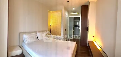 Spacious modern bedroom with elegant wooden flooring and ambient lighting