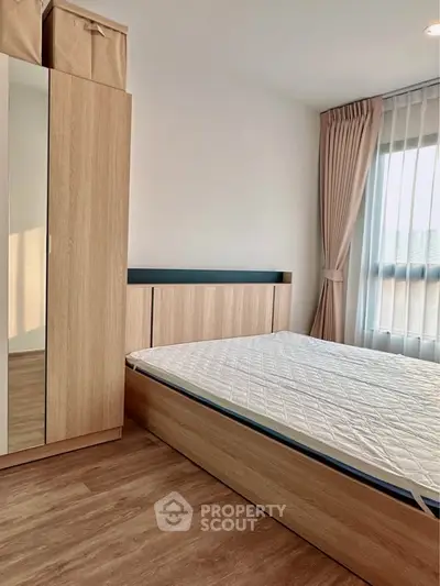 Modern bedroom with wooden furniture and natural light