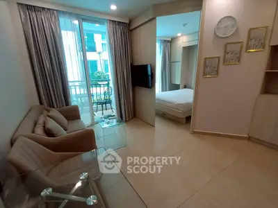 Modern apartment with open living room and bedroom, featuring a cozy balcony view.