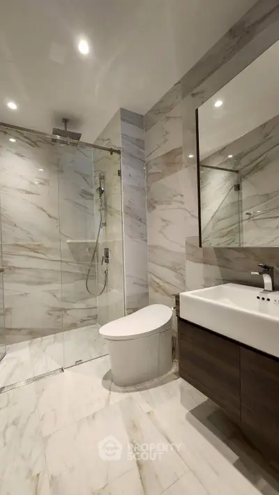 Luxurious modern bathroom with marble tiles and sleek fixtures