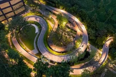 Stunning aerial view of illuminated winding pathways in a lush garden setting, perfect for evening strolls.