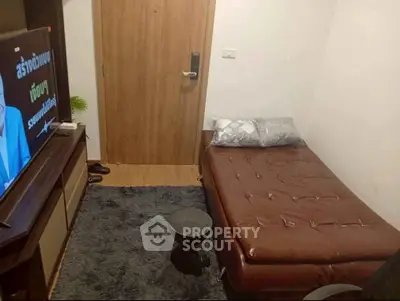 Cozy small bedroom with leather bed and modern TV setup