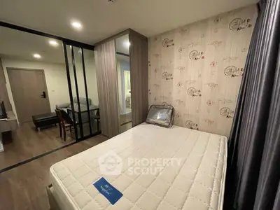 Modern bedroom with stylish decor and glass partition in a cozy apartment.