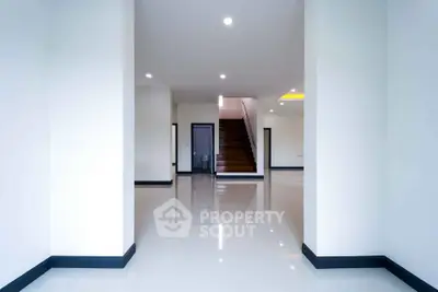 Spacious modern interior with sleek staircase and glossy floors