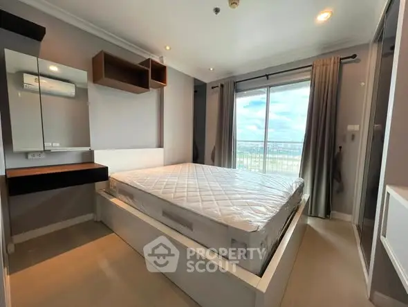 Modern bedroom with large window and stylish furnishings