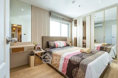 Modern bedroom with stylish decor, mirrored wardrobe, and cozy bedding in a bright apartment.