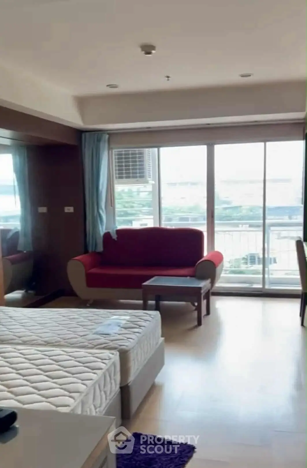 Spacious bedroom with balcony view and modern furnishings