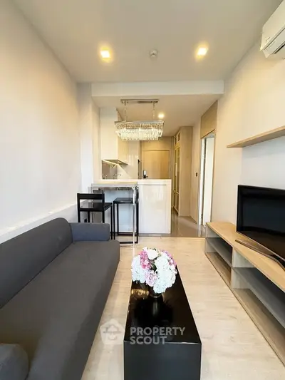 Modern living room with sleek furniture and elegant lighting in a stylish apartment.