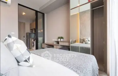 Modern bedroom with mirrored wardrobe and cozy decor in stylish apartment