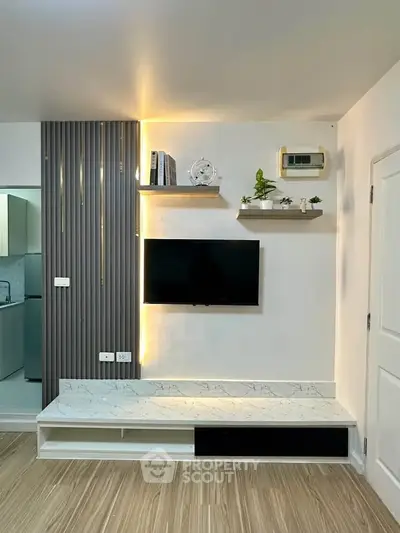 Modern living room with sleek TV setup and stylish shelving