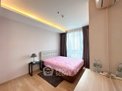 Modern bedroom with stylish lighting and cozy decor in a contemporary apartment.