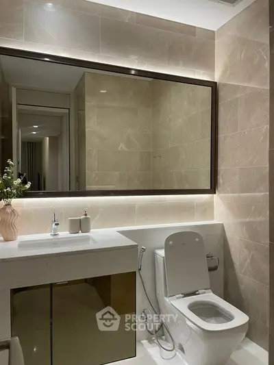 Luxurious modern bathroom with elegant fixtures and large mirror