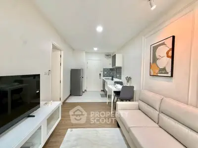 Modern living room with sleek furniture and open kitchen layout in a stylish apartment.