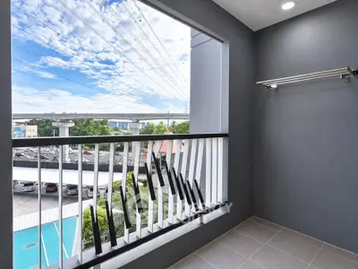 Modern balcony with sleek railing and pool view, perfect for relaxation and enjoying the outdoors.