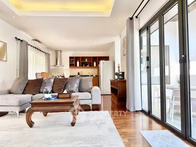 Spacious modern living room with open layout and large sliding glass doors leading to a balcony.