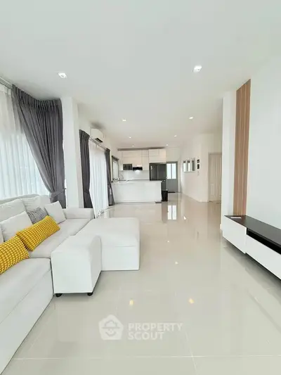 Spacious modern living room with open kitchen and elegant decor