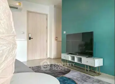Modern living room with stylish TV stand and vibrant teal accent wall