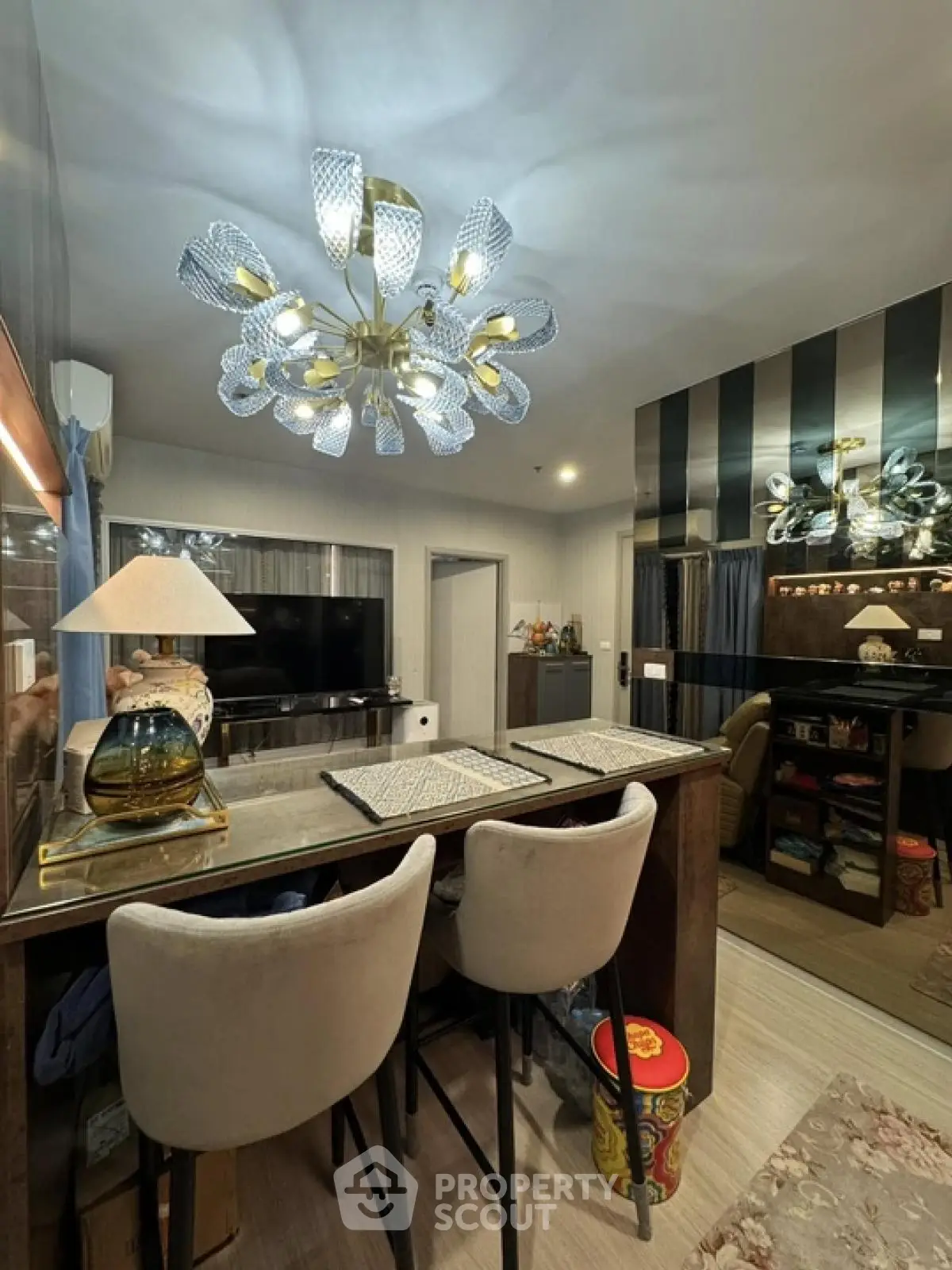 Stylish modern living room with elegant chandelier and cozy seating area