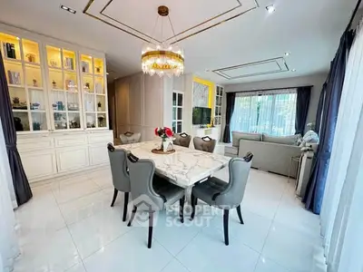 Luxurious dining and living room with elegant chandelier and marble table