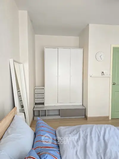 Cozy bedroom with modern wardrobe and stylish decor