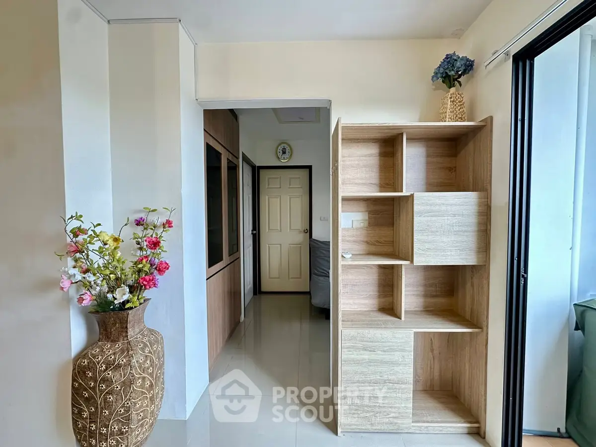 Modern interior with stylish shelving and floral decor in a bright living space.