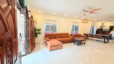 Spacious living room with elegant decor and open kitchen layout, perfect for modern living.