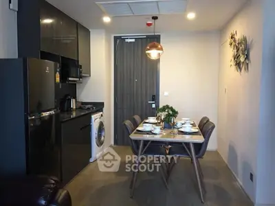 Modern kitchen and dining area with sleek appliances and stylish decor