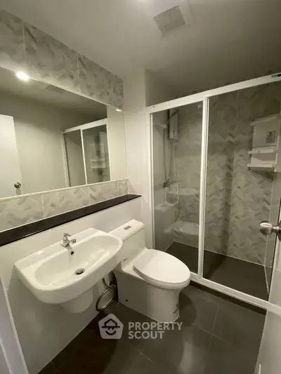 Modern bathroom with sleek fixtures and glass shower enclosure