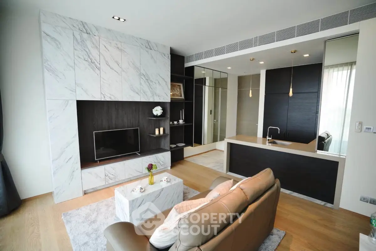 Luxurious modern living room with marble accents and open kitchen layout