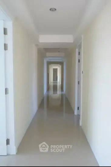 Bright and spacious corridor with polished floors in modern building