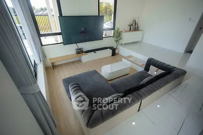 Spacious modern living room with large windows and stylish furniture