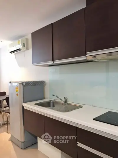 Modern kitchen with sleek cabinets and built-in appliances in a stylish apartment.