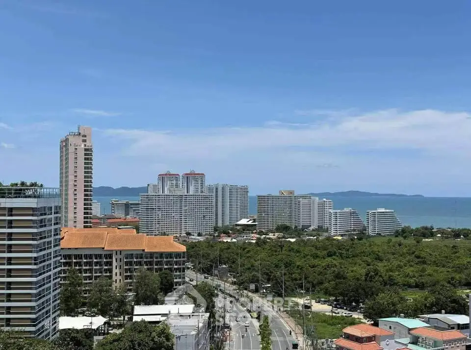 Stunning coastal cityscape with ocean view and modern high-rise buildings.