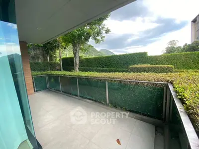 Spacious balcony with lush greenery and scenic mountain views