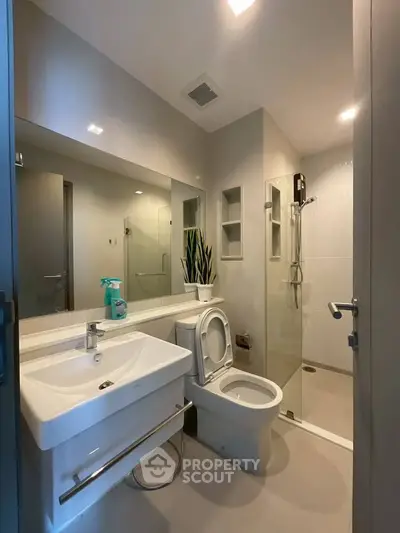 Modern bathroom with sleek fixtures and glass shower enclosure