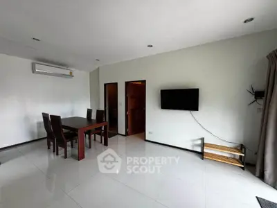 Spacious modern living room with dining area and wall-mounted TV