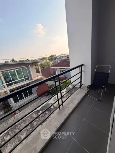 Charming balcony with scenic view of modern neighborhood, perfect for relaxation and enjoying the outdoors.