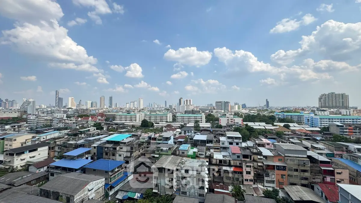 Stunning cityscape view showcasing urban skyline and residential buildings under a clear blue sky.