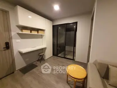 Modern minimalist living room with sleek furniture and large window.