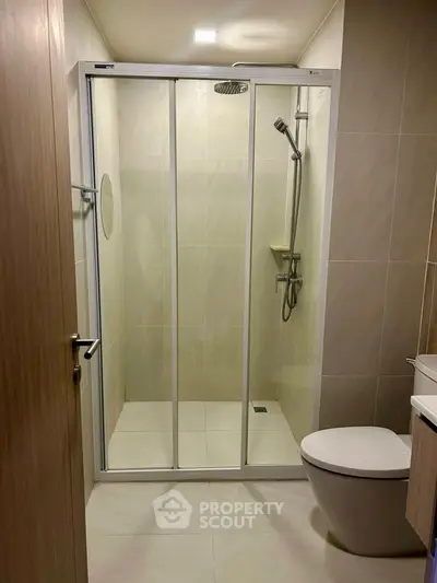 Modern bathroom with sleek shower enclosure and contemporary fixtures.