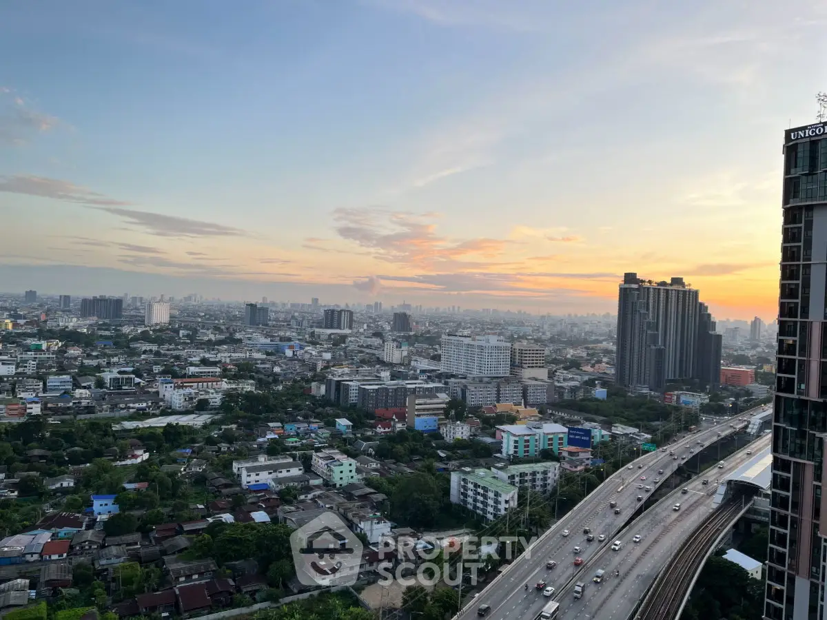 Stunning cityscape view from high-rise building at sunset, showcasing urban skyline and vibrant city life.